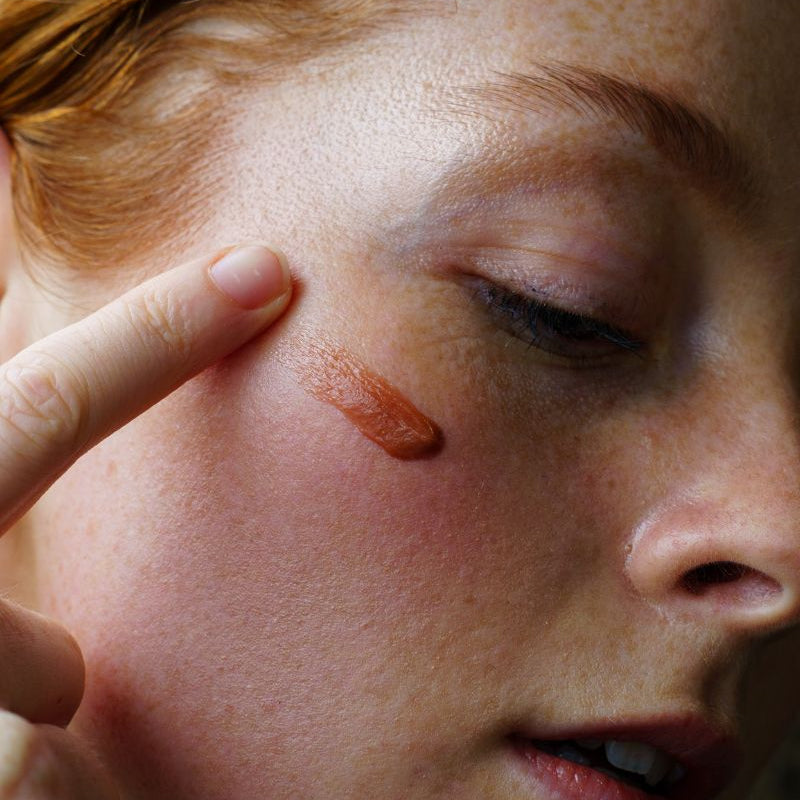 Close-up of a person with coffee date lip balm on their face
