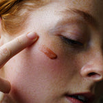 Close-up of a person with coffee date lip balm on their face